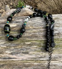 ceramic skulls  emerald and ebony  toned  glass beaded necklace 