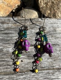 purple voodoo skulls with various wooden and glass beaded fish hook earrings