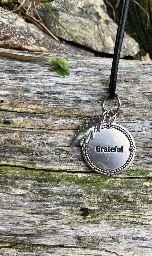 Grateful Dead  13 point lightning bolt  with beautiful stamped pendant that has the word "Grateful" embossed 