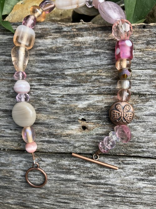 Hand beaded Bracelet  lamp work pink and cats eye dichroic and  neutral toned glass and crystal beads with a butterfly button copper bead copper toggle clasp 