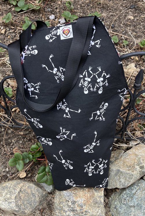 Handmade coffin bag by Lucky Burrito with dancing skeletons on black fabric with coordinating black, white and red graffiti fabric