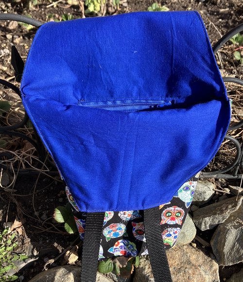 Handmade coffin bag by Lucky Burrito with cat skeletons on black fabric with coordinating blue fabric