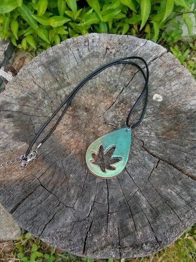 Resin teardrop cannabis leaf pendant black cord