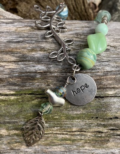 Nature themed beaded necklace with charms and leaf accents