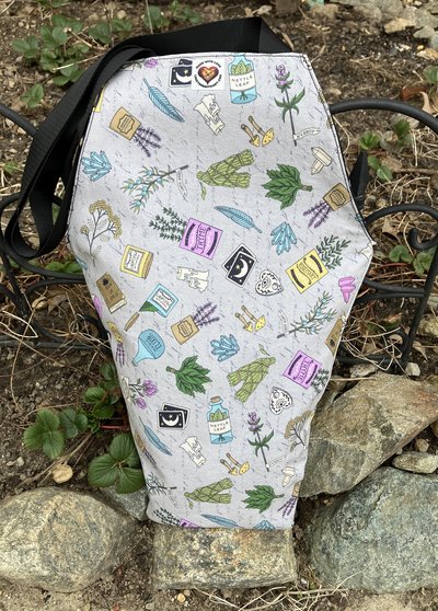 Handmade coffin bag by Lucky Burrito apothecary style with crystals, sage, candles, magic elixir, book of spells, mushroom fabric